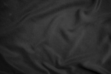 Arkaplan dokusu siyah kumaş. Soyut koyu dalgalı yumuşak. Kumaş kırışmış. Lüks moda tarzı..