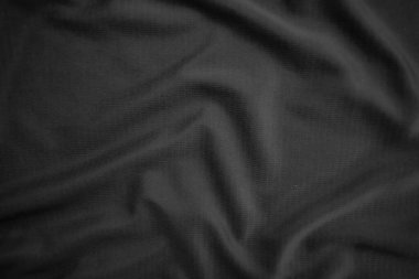 Arkaplan dokusu siyah kumaş. Soyut koyu dalgalı yumuşak. Kumaş kırışmış. Lüks moda tarzı..