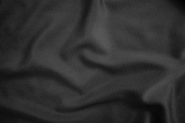 Arkaplan dokusu siyah kumaş. Soyut koyu dalgalı yumuşak. Kumaş kırışmış. Lüks moda tarzı..