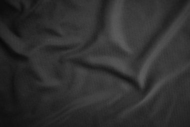 Arkaplan dokusu siyah kumaş. Soyut koyu dalgalı yumuşak. Kumaş kırışmış. Lüks moda tarzı..