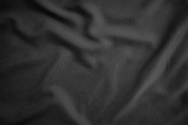 Arkaplan dokusu siyah kumaş. Soyut koyu dalgalı yumuşak. Kumaş kırışmış. Lüks moda tarzı..