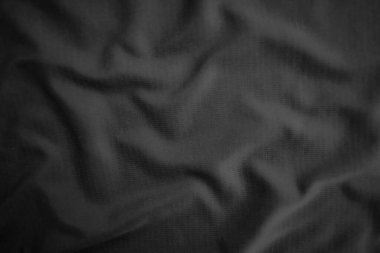 Arkaplan dokusu siyah kumaş. Soyut koyu dalgalı yumuşak. Kumaş kırışmış. Lüks moda tarzı..