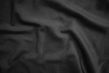 Arkaplan dokusu siyah kumaş. Soyut koyu dalgalı yumuşak. Kumaş kırışmış. Lüks moda tarzı..