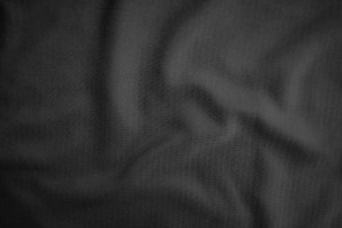 Arkaplan dokusu siyah kumaş. Soyut koyu dalgalı yumuşak. Kumaş kırışmış. Lüks moda tarzı..