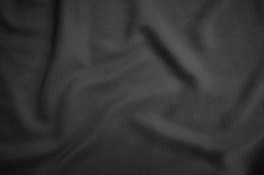 Arkaplan dokusu siyah kumaş. Soyut koyu dalgalı yumuşak. Kumaş kırışmış. Lüks moda tarzı..