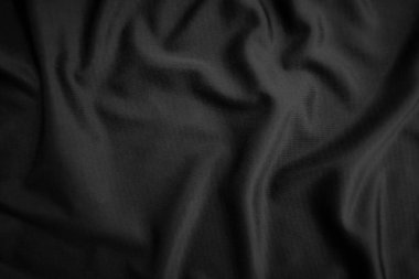 Arkaplan dokusu siyah kumaş. Soyut koyu dalgalı yumuşak. Kumaş kırışmış. Lüks moda tarzı..