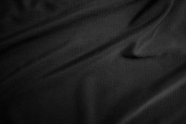 Arkaplan dokusu siyah kumaş. Soyut koyu dalgalı yumuşak. Kumaş kırışmış. Lüks moda tarzı..