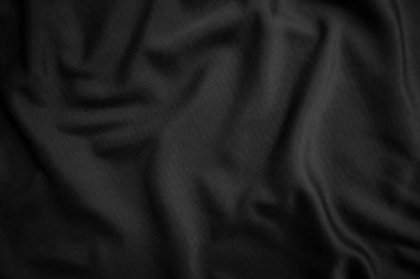 Arkaplan dokusu siyah kumaş. Soyut koyu dalgalı yumuşak. Kumaş kırışmış. Lüks moda tarzı..