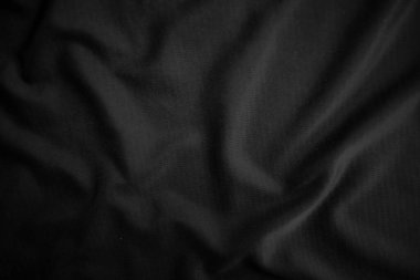 Arkaplan dokusu siyah kumaş. Soyut koyu dalgalı yumuşak. Kumaş kırışmış. Lüks moda tarzı..