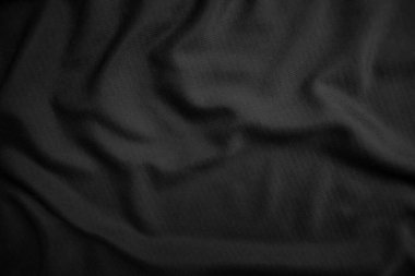 Arkaplan dokusu siyah kumaş. Soyut koyu dalgalı yumuşak. Kumaş kırışmış. Lüks moda tarzı..
