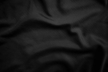 Arkaplan dokusu siyah kumaş. Soyut koyu dalgalı yumuşak. Kumaş kırışmış. Lüks moda tarzı..