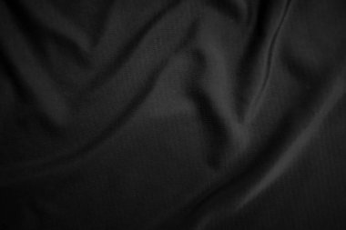 Arkaplan dokusu siyah kumaş. Soyut koyu dalgalı yumuşak. Kumaş kırışmış. Lüks moda tarzı..