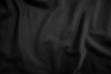 Arkaplan dokusu siyah kumaş. Soyut koyu dalgalı yumuşak. Kumaş kırışmış. Lüks moda tarzı..