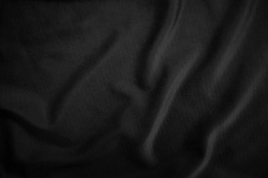 Arkaplan dokusu siyah kumaş. Soyut koyu dalgalı yumuşak. Kumaş kırışmış. Lüks moda tarzı..