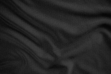 Arkaplan dokusu siyah kumaş. Soyut koyu dalgalı yumuşak. Kumaş kırışmış. Lüks moda tarzı..