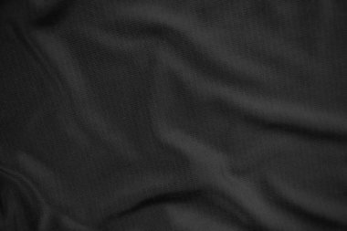 Arkaplan dokusu siyah kumaş. Soyut koyu dalgalı yumuşak. Kumaş kırışmış. Lüks moda tarzı..