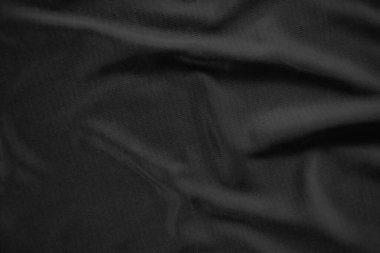 Arkaplan dokusu siyah kumaş. Soyut koyu dalgalı yumuşak. Kumaş kırışmış. Lüks moda tarzı..