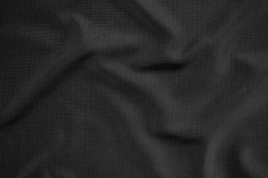 Arkaplan dokusu siyah kumaş. Soyut koyu dalgalı yumuşak. Kumaş kırışmış. Lüks moda tarzı..