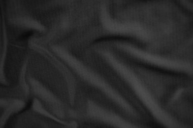 Arkaplan dokusu siyah kumaş. Soyut koyu dalgalı yumuşak. Kumaş kırışmış. Lüks moda tarzı..