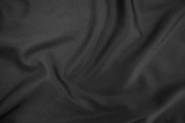 Arkaplan dokusu siyah kumaş. Soyut koyu dalgalı yumuşak. Kumaş kırışmış. Lüks moda tarzı..