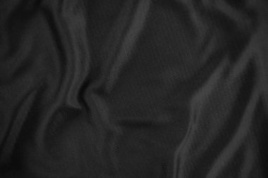 Arkaplan dokusu siyah kumaş. Soyut koyu dalgalı yumuşak. Kumaş kırışmış. Lüks moda tarzı..