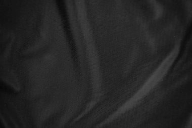Arkaplan dokusu siyah kumaş. Soyut koyu dalgalı yumuşak. Kumaş kırışmış. Lüks moda tarzı..