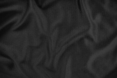 Arkaplan dokusu siyah kumaş. Soyut koyu dalgalı yumuşak. Kumaş kırışmış. Lüks moda tarzı..