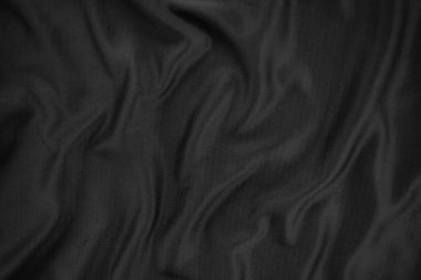 Arkaplan dokusu siyah kumaş. Soyut koyu dalgalı yumuşak. Kumaş kırışmış. Lüks moda tarzı..