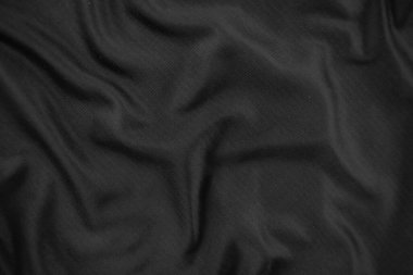 Arkaplan dokusu siyah kumaş. Soyut koyu dalgalı yumuşak. Kumaş kırışmış. Lüks moda tarzı..