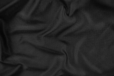 Arkaplan dokusu siyah kumaş. Soyut koyu dalgalı yumuşak. Kumaş kırışmış. Lüks moda tarzı..