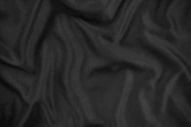 Arkaplan dokusu siyah kumaş. Soyut koyu dalgalı yumuşak. Kumaş kırışmış. Lüks moda tarzı..