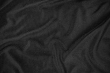 Arkaplan dokusu siyah kumaş. Soyut koyu dalgalı yumuşak. Kumaş kırışmış. Lüks moda tarzı..