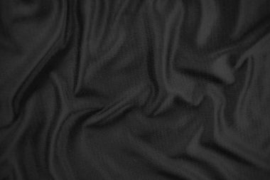 Arkaplan dokusu siyah kumaş. Soyut koyu dalgalı yumuşak. Kumaş kırışmış. Lüks moda tarzı..