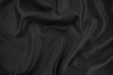 Arkaplan dokusu siyah kumaş. Soyut koyu dalgalı yumuşak. Kumaş kırışmış. Lüks moda tarzı..