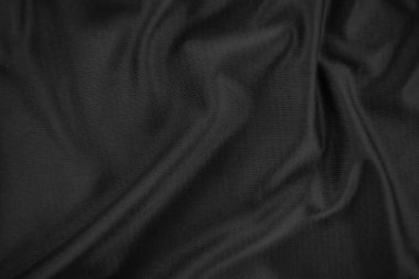 Arkaplan dokusu siyah kumaş. Soyut koyu dalgalı yumuşak. Kumaş kırışmış. Lüks moda tarzı..