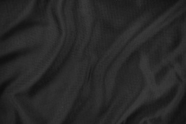 Arkaplan dokusu siyah kumaş. Soyut koyu dalgalı yumuşak. Kumaş kırışmış. Lüks moda tarzı..