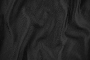 Arkaplan dokusu siyah kumaş. Soyut koyu dalgalı yumuşak. Kumaş kırışmış. Lüks moda tarzı..