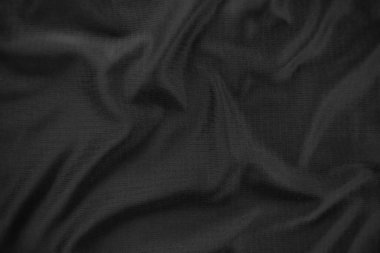 Arkaplan dokusu siyah kumaş. Soyut koyu dalgalı yumuşak. Kumaş kırışmış. Lüks moda tarzı..
