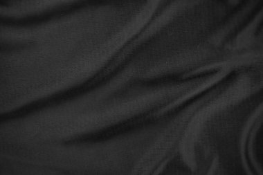Arkaplan dokusu siyah kumaş. Soyut koyu dalgalı yumuşak. Kumaş kırışmış. Lüks moda tarzı..