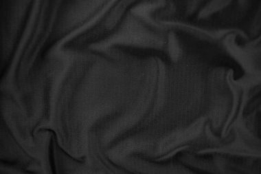 Arkaplan dokusu siyah kumaş. Soyut koyu dalgalı yumuşak. Kumaş kırışmış. Lüks moda tarzı..