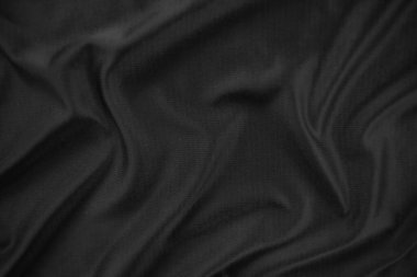 Arkaplan dokusu siyah kumaş. Soyut koyu dalgalı yumuşak. Kumaş kırışmış. Lüks moda tarzı..