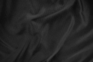Arkaplan dokusu siyah kumaş. Soyut koyu dalgalı yumuşak. Kumaş kırışmış. Lüks moda tarzı..