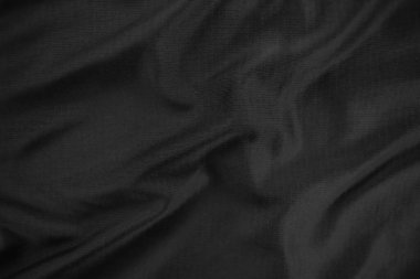 Arkaplan dokusu siyah kumaş. Soyut koyu dalgalı yumuşak. Kumaş kırışmış. Lüks moda tarzı..