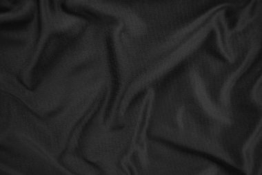 Arkaplan dokusu siyah kumaş. Soyut koyu dalgalı yumuşak. Kumaş kırışmış. Lüks moda tarzı..