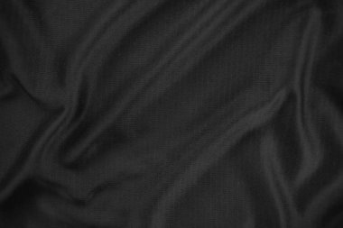 Arkaplan dokusu siyah kumaş. Soyut koyu dalgalı yumuşak. Kumaş kırışmış. Lüks moda tarzı..