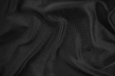 Arkaplan dokusu siyah kumaş. Soyut koyu dalgalı yumuşak. Kumaş kırışmış. Lüks moda tarzı..