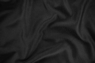 Arkaplan dokusu siyah kumaş. Soyut koyu dalgalı yumuşak. Kumaş kırışmış. Lüks moda tarzı..
