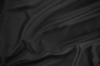 Arkaplan dokusu siyah kumaş. Soyut koyu dalgalı yumuşak. Kumaş kırışmış. Lüks moda tarzı..