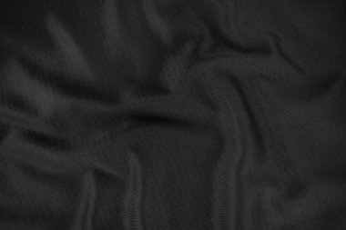 Arkaplan dokusu siyah kumaş. Soyut koyu dalgalı yumuşak. Kumaş kırışmış. Lüks moda tarzı..