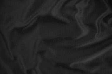 Arkaplan dokusu siyah kumaş. Soyut koyu dalgalı yumuşak. Kumaş kırışmış. Lüks moda tarzı..